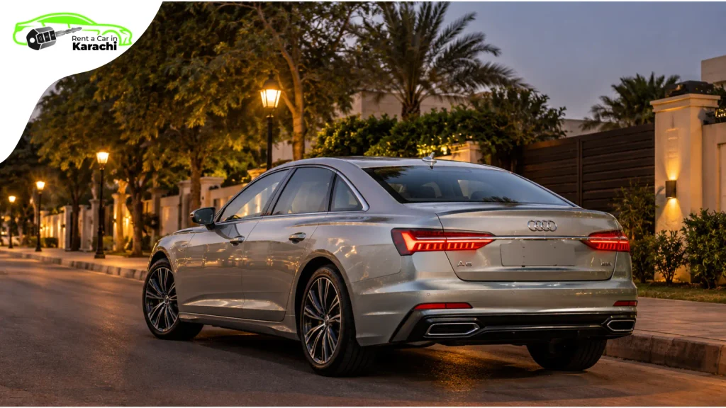 Sleek silver Audi A6 parked under evening streetlights in Clifton Karachi during a luxury wedding car rental evening session